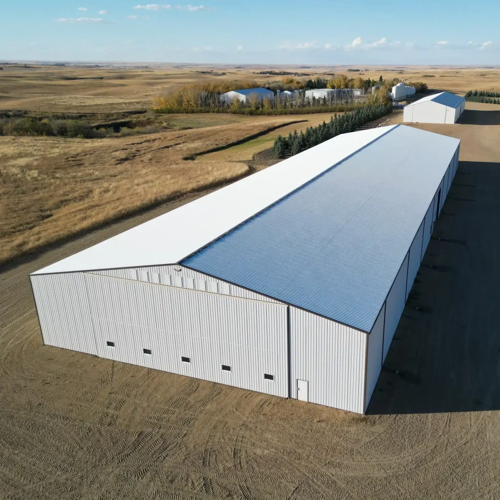 A white white post-frame agricultural storage building