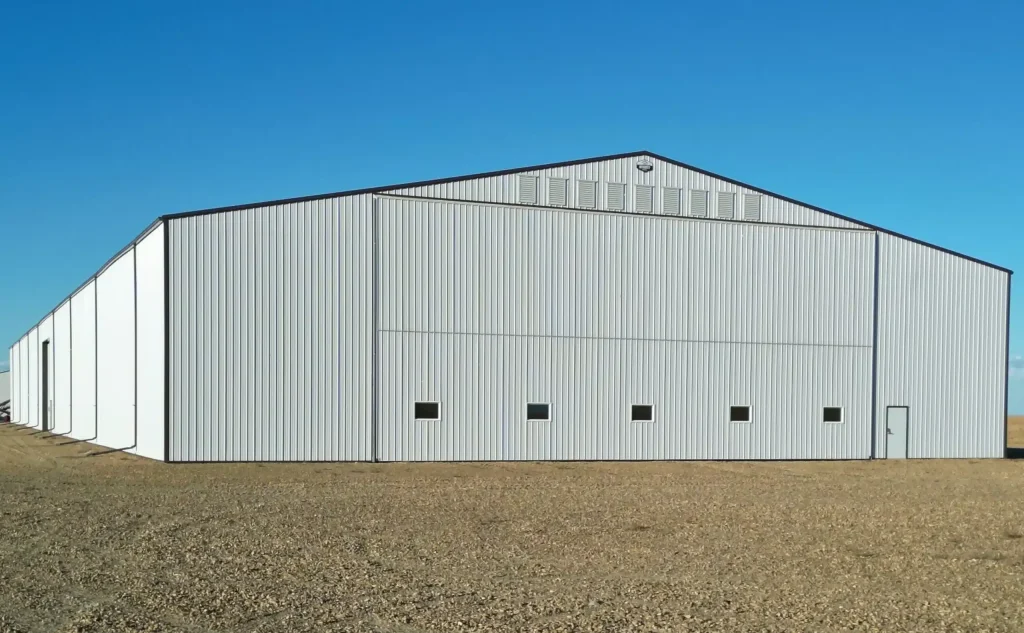 A white white post-frame agricultural storage building