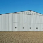 A white white post-frame agricultural storage building