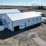 A white white post-frame Agricultural shop and museum.