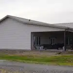 A post-frame highwood with garage residential build