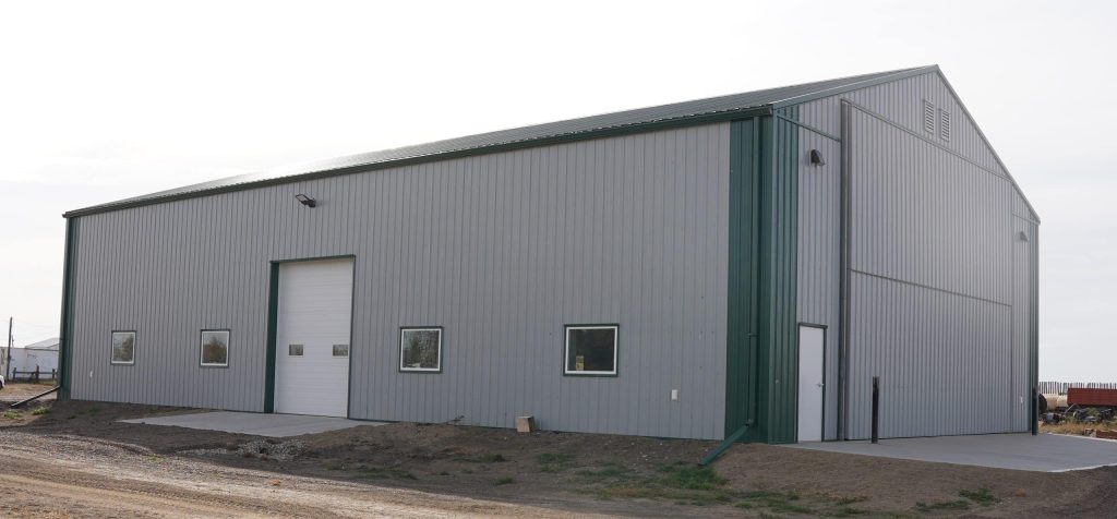 A post-frame agricultural shop with overhead door
