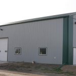 A post-frame agricultural shop with overhead door