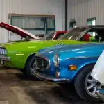 A dark red post-frame equestrian barn