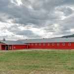 A post-frame equestrian riding arena