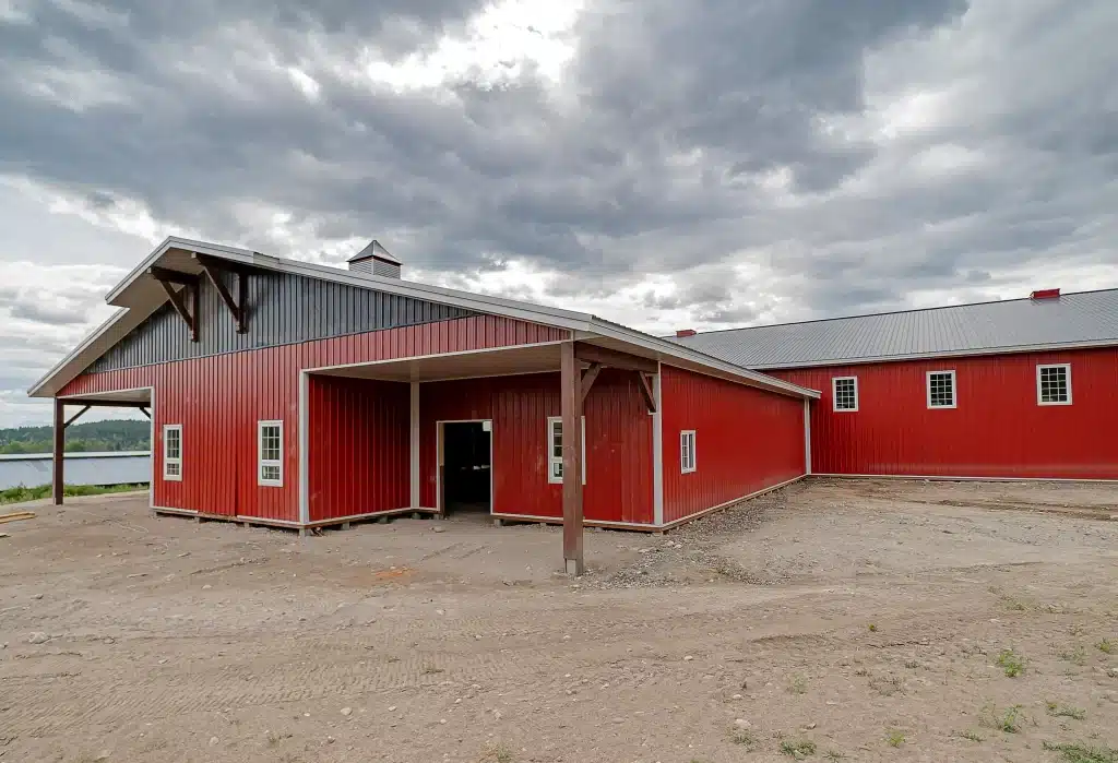 A post-frame equestrian riding arena