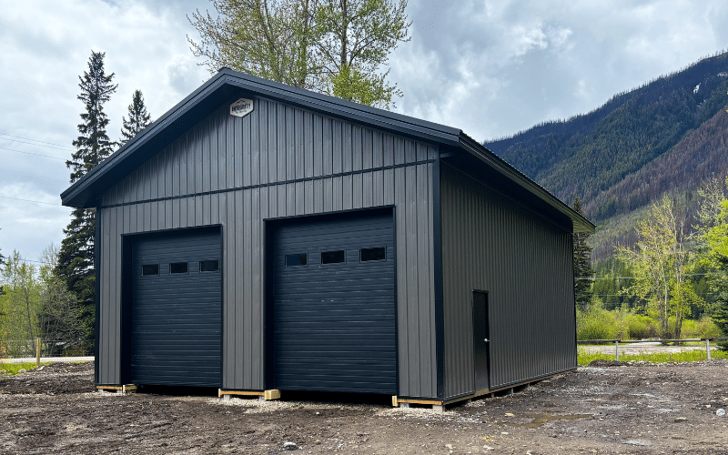 A charcoal post-frame lifestyle & hobby shop with two overhead doors