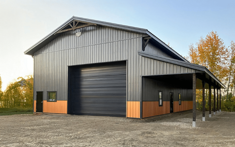 A charcoal post-frame lifestyle & hobby shop with wainscoting, soffits, timber accents, an open lean-to and one overhead door