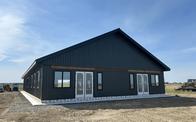 An iron ore post-frame Bunk House with soffits and a black roof