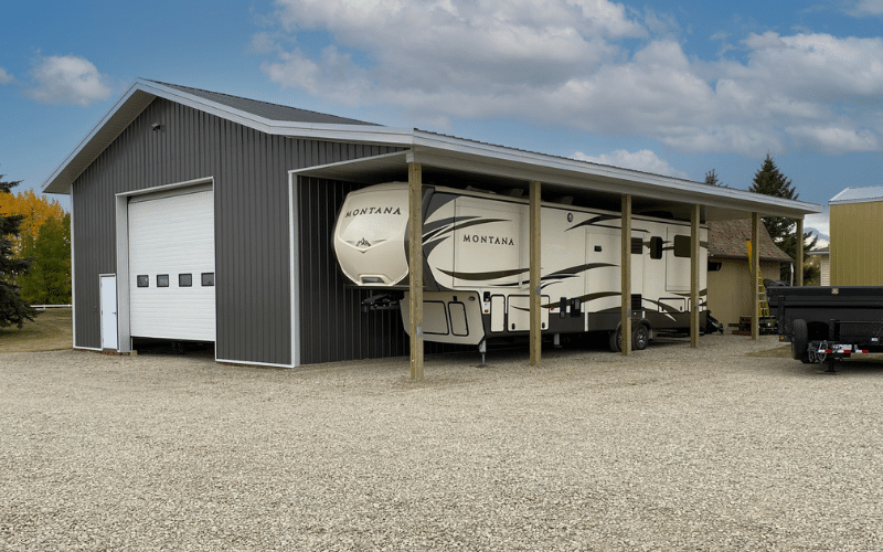 A charcoal post-frame lifestyle & hobby storage building with an open lean-to, one overhead door and soffits