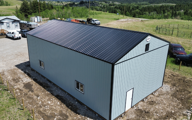 A regent grey post-frame agricultural shop with two overhead doors
