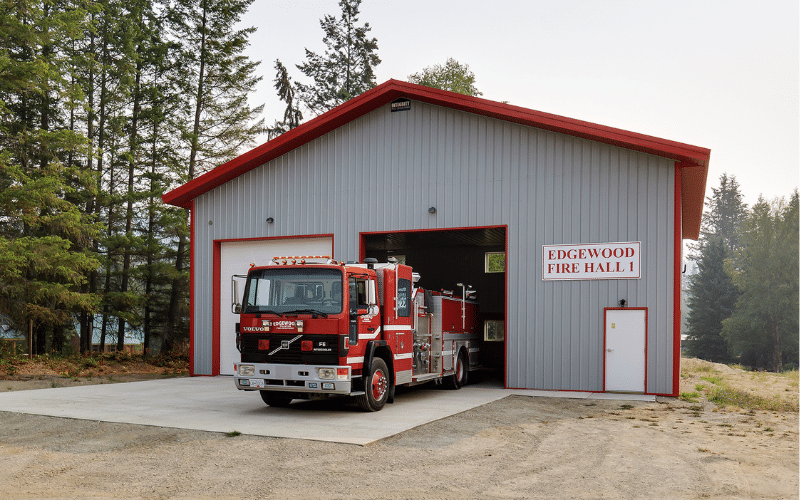 A Regent Grey post-frame Commercial FireHall with overhead door and soffits