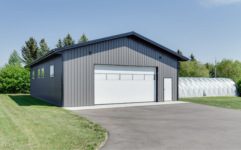 A Charcoal post-frame Lifestyler & Hobby Shop with overhead door, and soffits.