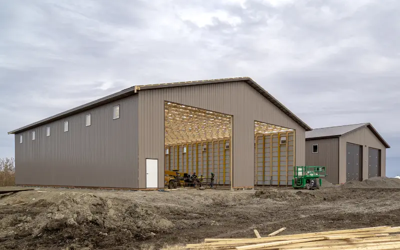 A buckskin post-frame agricultural storage building with findoors
