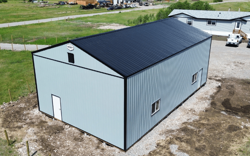 A regent grey post-frame agricultural shop with two overhead doors