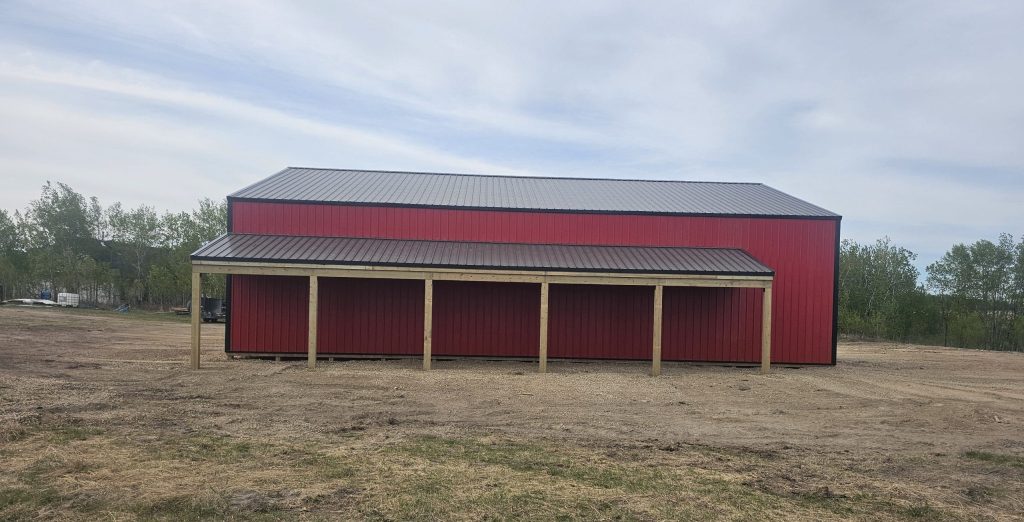 A bright red post-frame agricultural shop