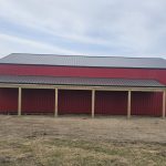A bright red post-frame agricultural shop