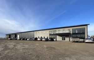 A gunmetal post-frame commercial building by Integrity Post Structures