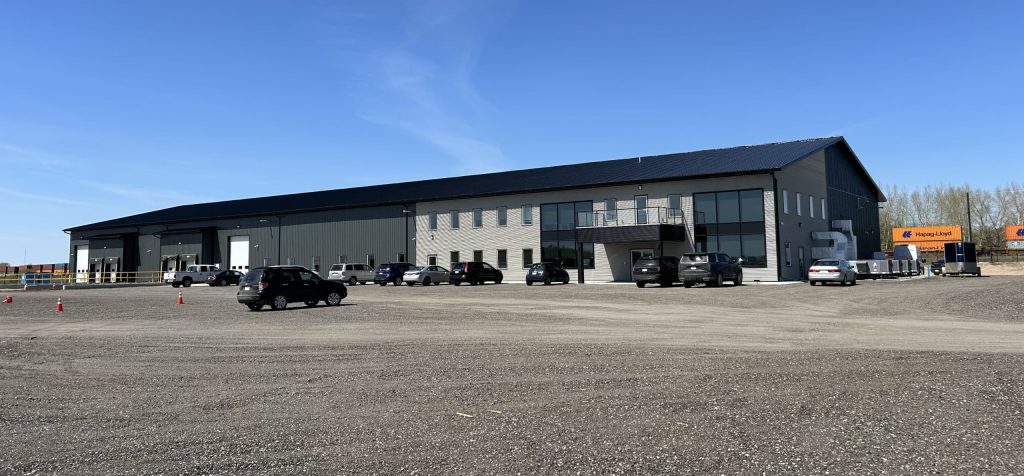 A gunmetal post-frame commercial building