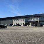 A gunmetal post-frame commercial building