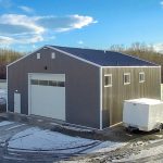 A charcoal post-frame lifestyle & hobby shop with overhead doors