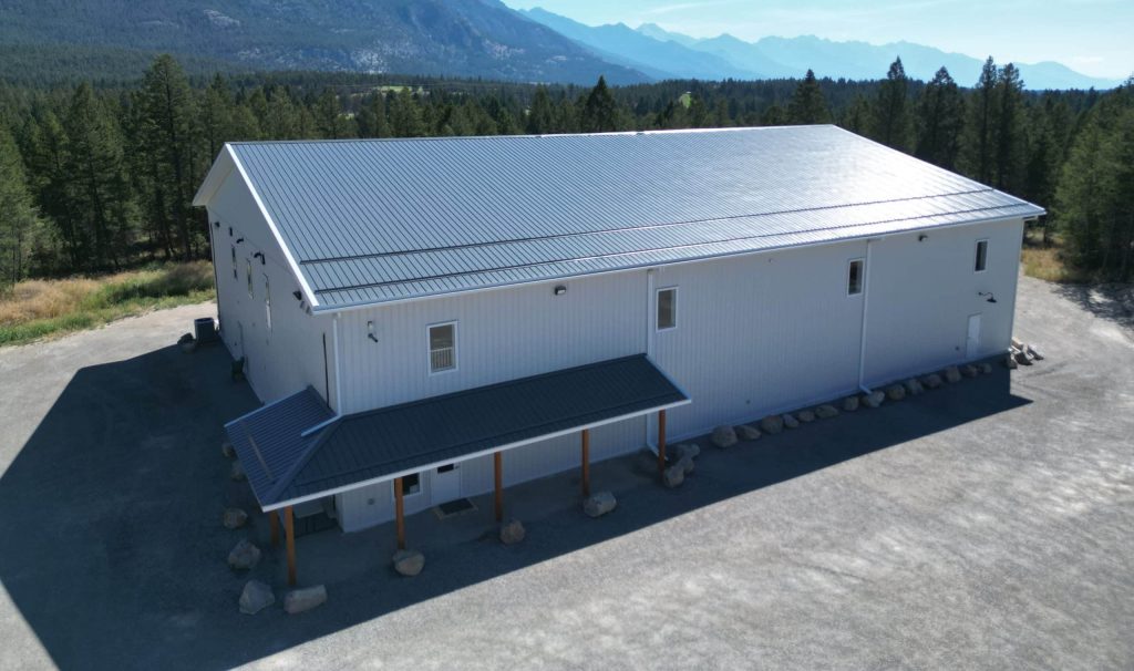 A white white post-frame commercial gymnastics studio with soffits