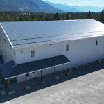 A white white post-frame commercial gymnastics studio with soffits