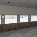 A stone grey post-frame equestrian riding Arena