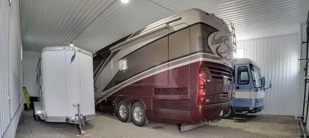 A light stone post-frame lifestyle & hobby shop with a bi-fold door and dark brown roof