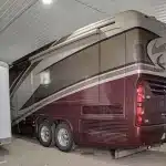 A light stone post-frame lifestyle & hobby shop with a bi-fold door and dark brown roof