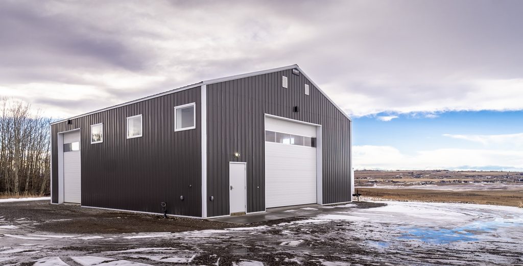 A charcoal post-frame lifestyle & hobby shop with overhead doors
