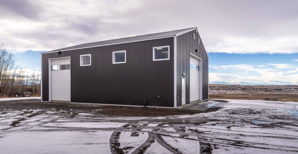 A charcoal post-frame lifestyle & hobby shop with overhead doors