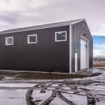 A charcoal post-frame lifestyle & hobby shop with overhead doors