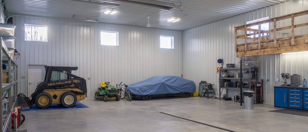 A charcoal post-frame lifestyle & hobby shop with overhead doors