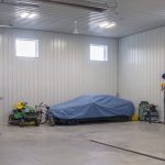 A charcoal post-frame lifestyle & hobby shop with overhead doors