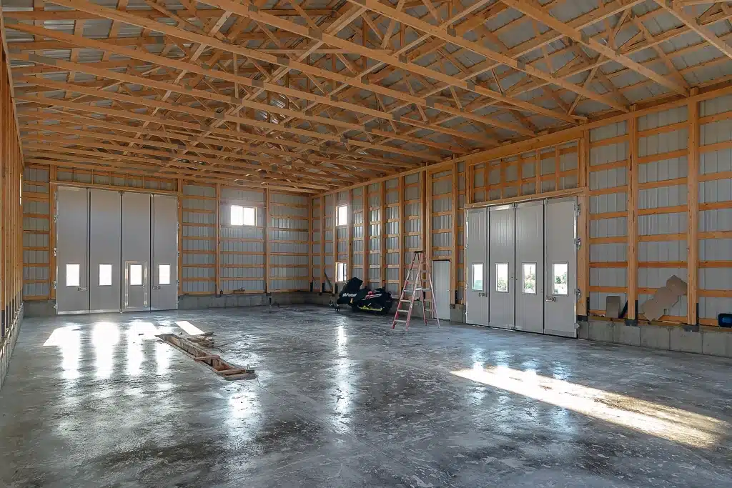 A charcoal post-frame agriculture shop with findoors