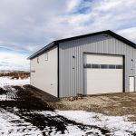 An ascot grey post-frame lifestyle & Hobby shop with an overhead door