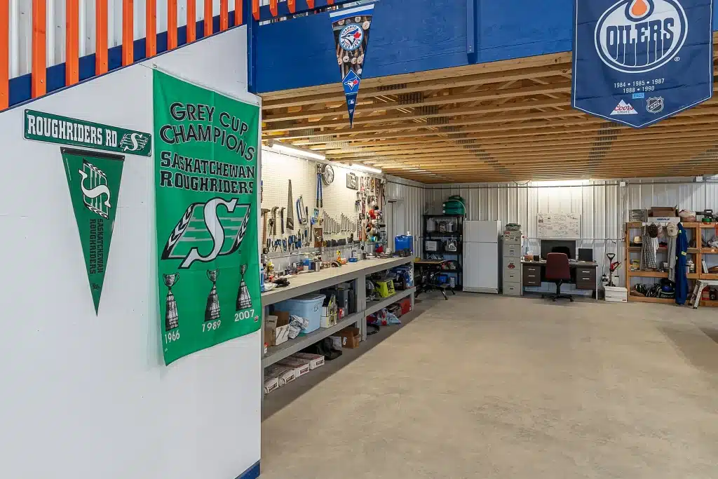 An ascot grey post-frame lifestyle & Hobby shop with an overhead door