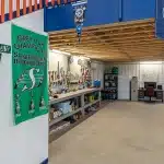 An ascot grey post-frame lifestyle & Hobby shop with an overhead door