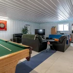 An ascot grey post-frame lifestyle & Hobby shop with an overhead door