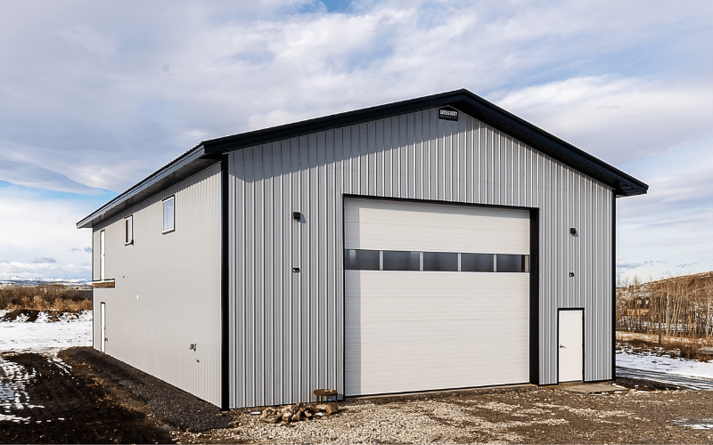 An ascot grey post-frame lifestyle & Hobby shop with an overhead door