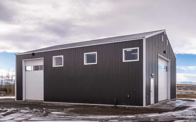 A charcoal post-frame lifestyle & hobby shop with overhead doors