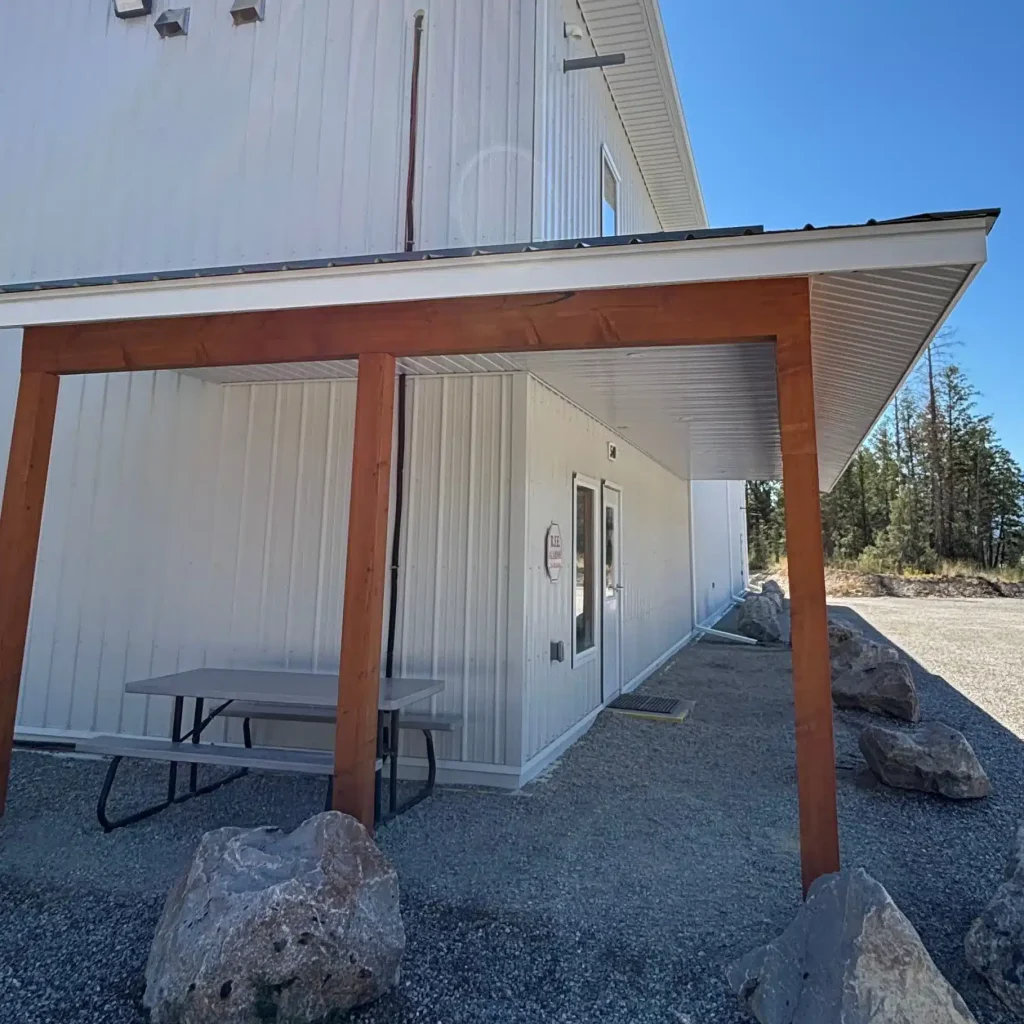 A white white post-frame commercial gymnastics studio with soffits