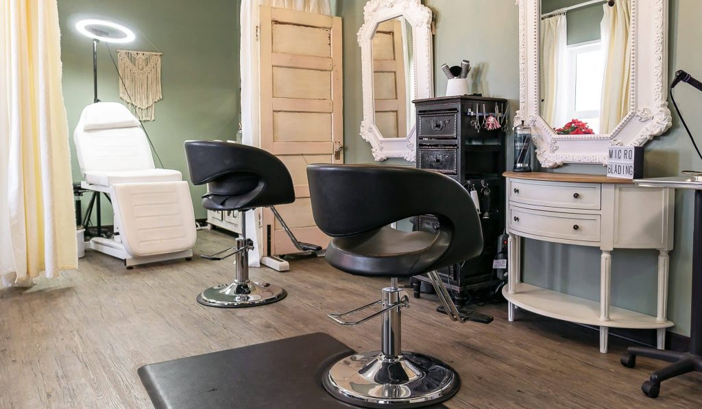 A dark sage commercial shop with a front porch and open lean-to