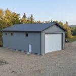 A regent grey post-frame lifestyle & hobby shop with soffits and a overhead door