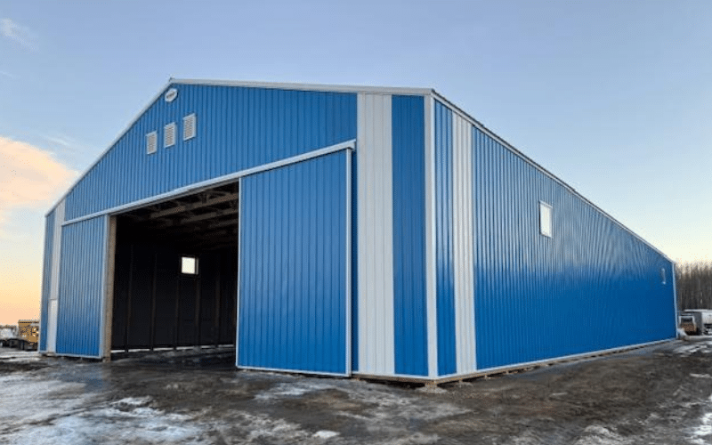 A royal blue post-frame storage building with a galvanized roof