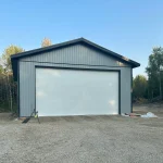 A regent grey post-frame lifestyle & hobby shop with soffits and a overhead door