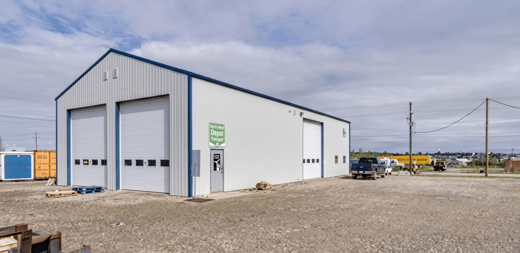 A bone white post-frame commercial shop with heron blue exterior trims