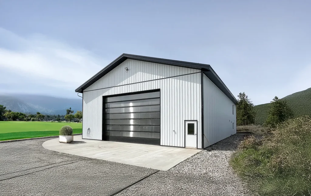 A bright white post-frame Residential Shouse with soffits and an overhead door