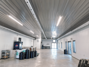 Interior of Nanton Golf Club post-frame storage building with white liner panel